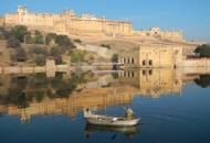 2 local men in a boat across the water from the magnificant Amber Fort