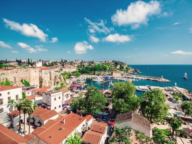 The town of Fethiye perched on the side of a mountain, overlooking to water