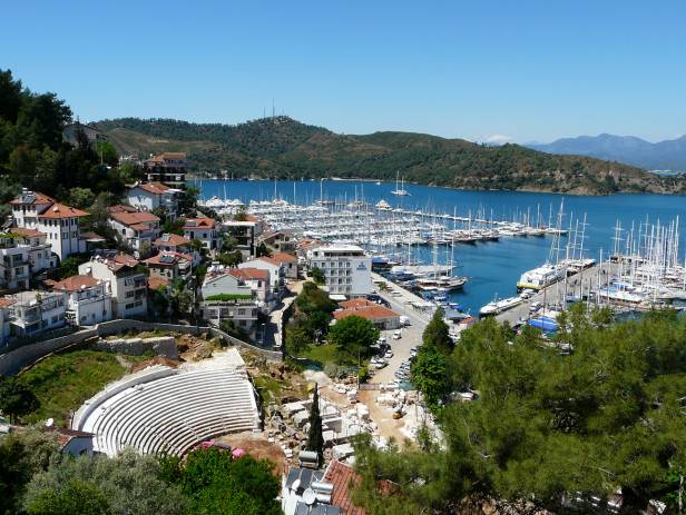 The town of Fethiye perched on the side of a mountain, overlooking to water