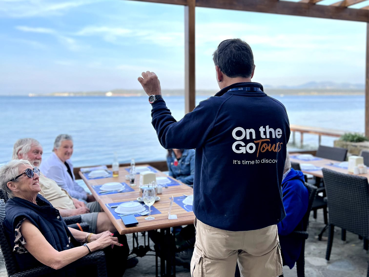 A group of tourists having a meal with a tour guide