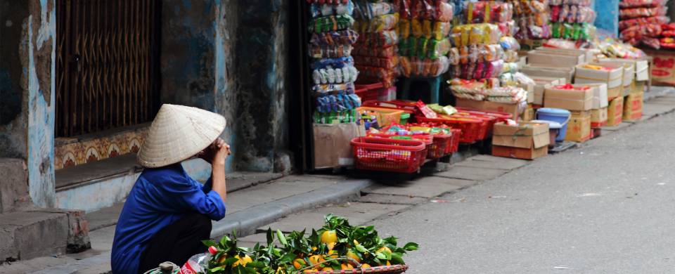 Hawker selling wares on the streets of Hanoi