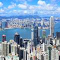 Train riding in front of the cityscape of Hong Kong