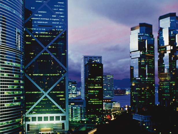 Train riding in front of the cityscape of Hong Kong