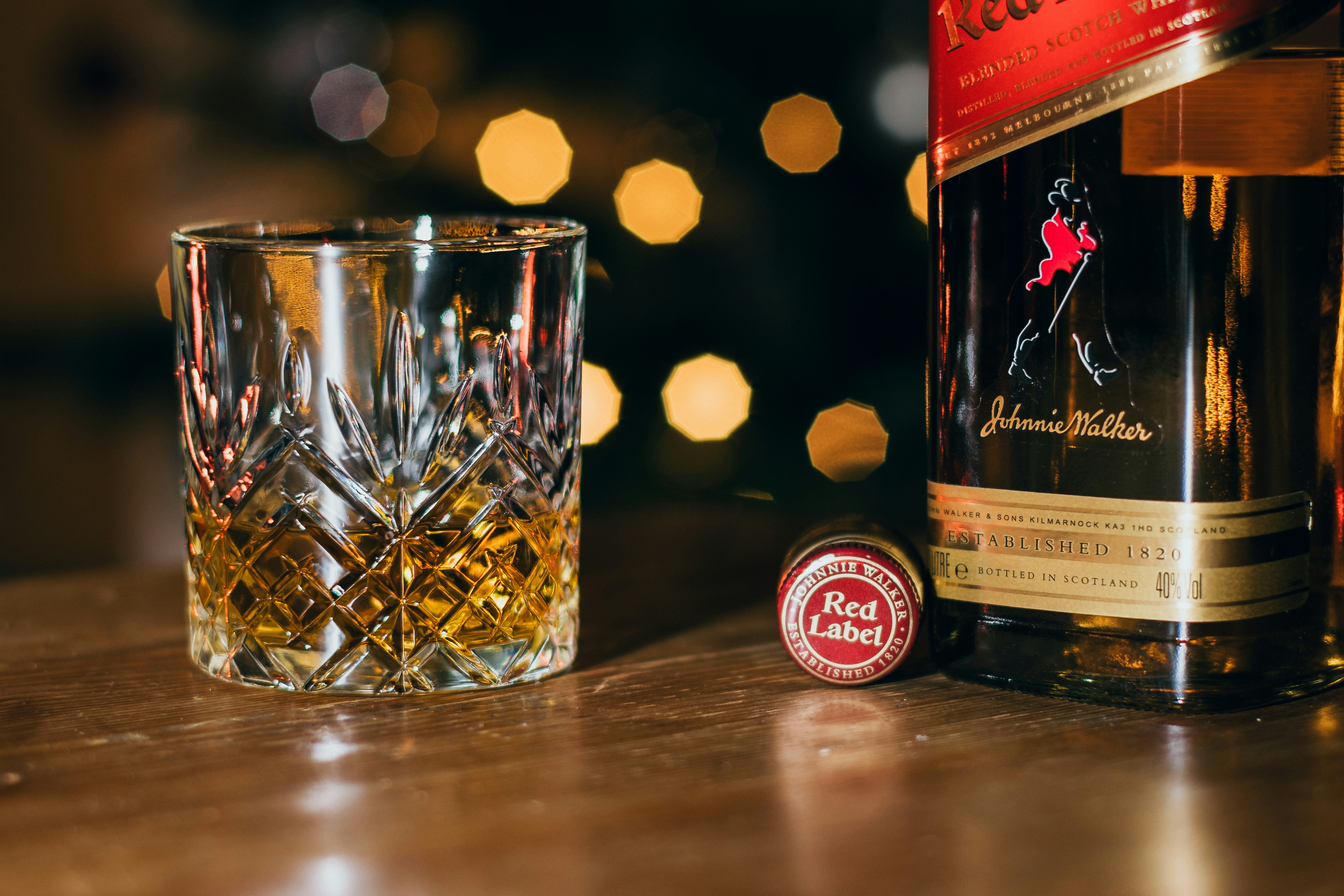 Johnnie Walker red label whisky being poured into a glass