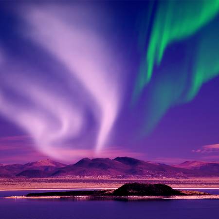 Northern Lights against purple sky - Iceland - On The Go Tours