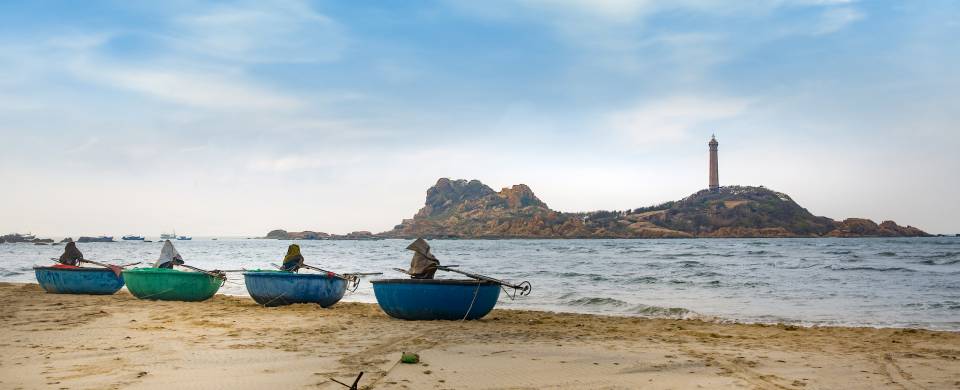 Boats along the edge of the water at the beach in Phan Thiet