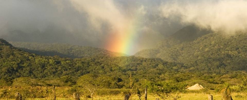 Rainbow touching the meadows surrounding the Rincon de la Vieja Volcano