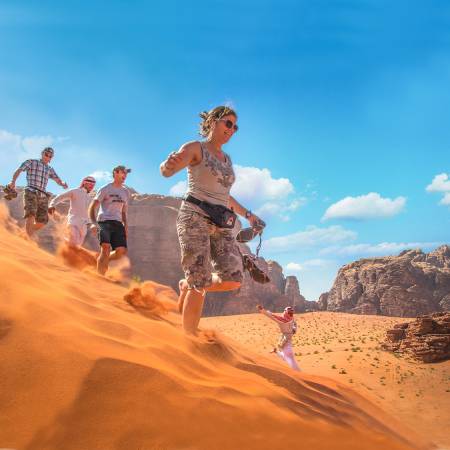 Running down dunes in Wadi Rum - Jordan tours - On the go Tours