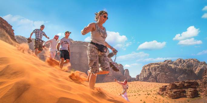 Running down dunes in Wadi Rum - Jordan tours - On the go Tours