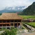 Lush green scenery stretching out to meet towering mountains in Mai Chau