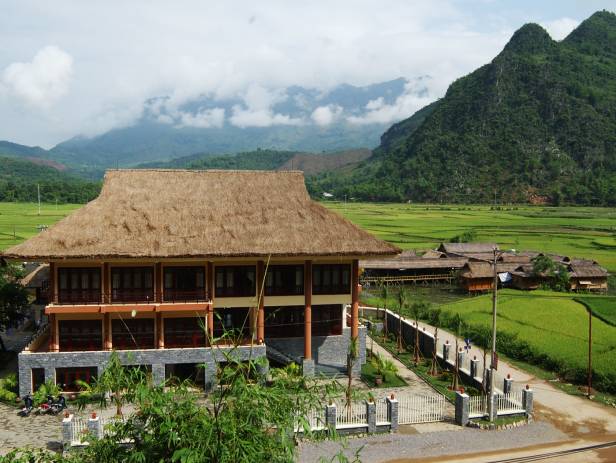 Lush green scenery stretching out to meet towering mountains in Mai Chau