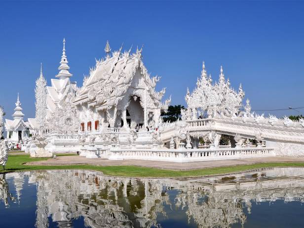 White Buddha statue in front of one of the many temples of Chiang Mai