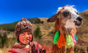 Young boy with a llama - Peru Tours - South America Tours - On The Go Tours