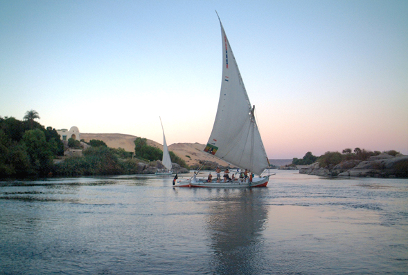 a felucca boat with people walking around the deck